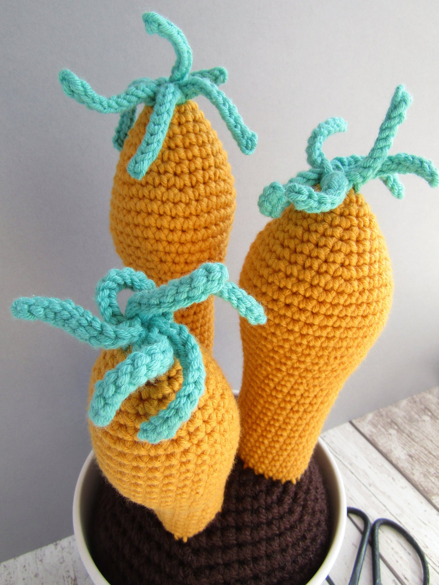 Quirky crocheted plant in mustard and teal